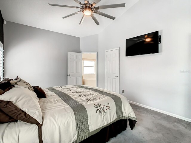 carpeted bedroom with ceiling fan and vaulted ceiling