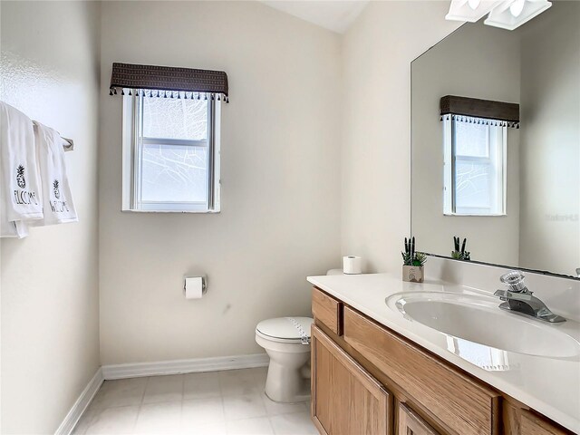 bathroom featuring vanity, toilet, and tile patterned floors