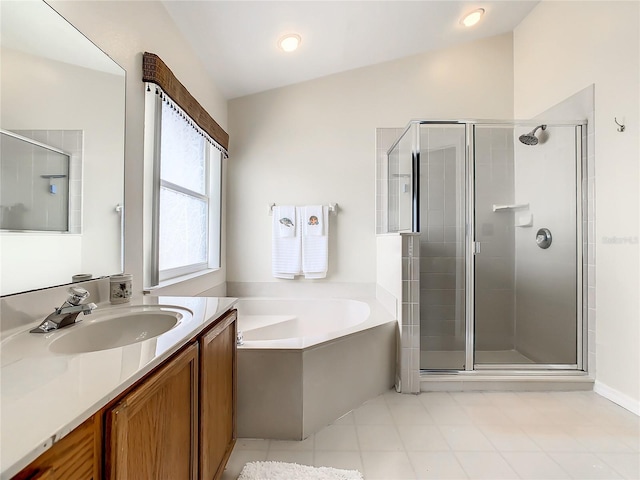 full bathroom featuring lofted ceiling, a garden tub, a stall shower, tile patterned floors, and vanity