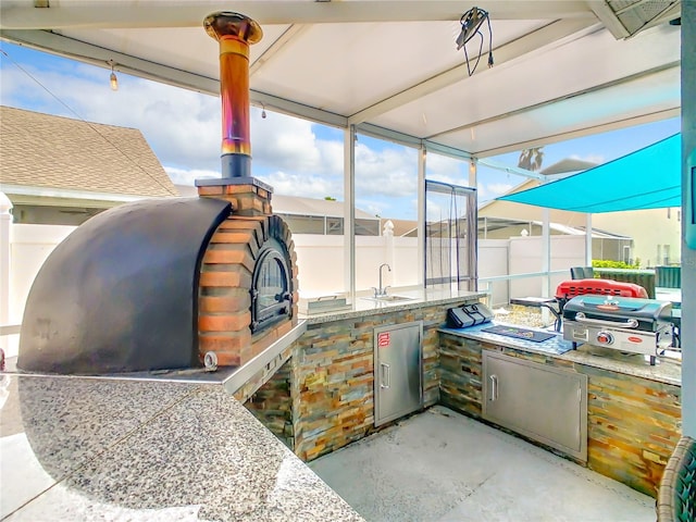 view of patio / terrace with a grill, sink, and area for grilling