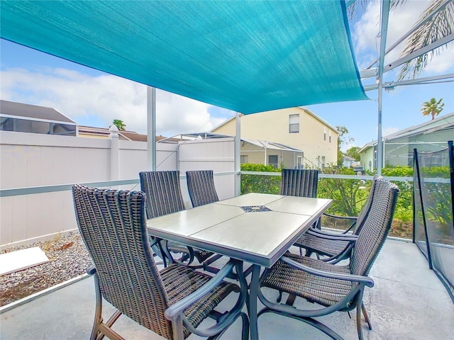 view of patio featuring outdoor dining space and fence