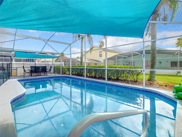 view of swimming pool featuring a patio and glass enclosure