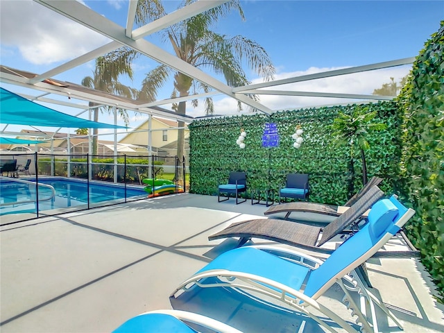 view of pool with a lanai and a patio