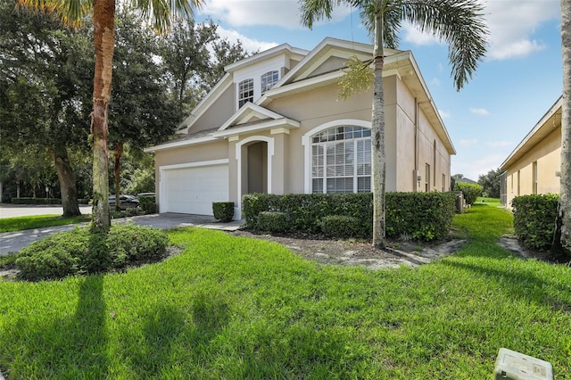 view of front of house featuring a garage and a front lawn