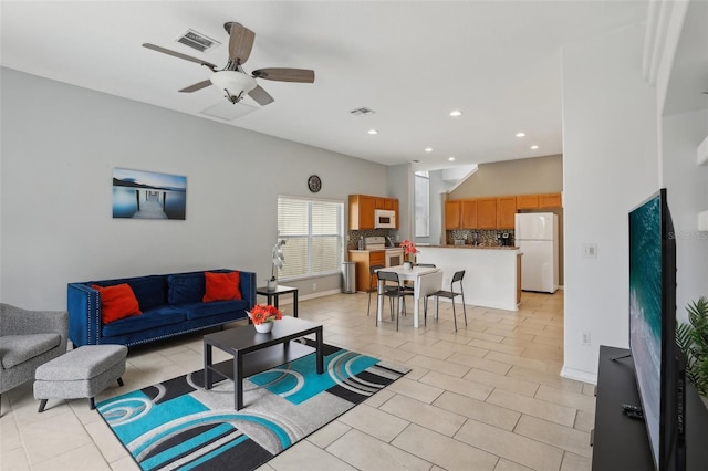 living room with light tile patterned floors and ceiling fan