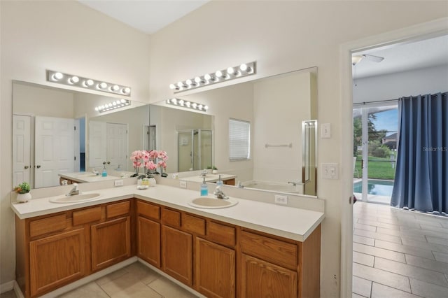 bathroom featuring tile patterned flooring, vanity, and separate shower and tub