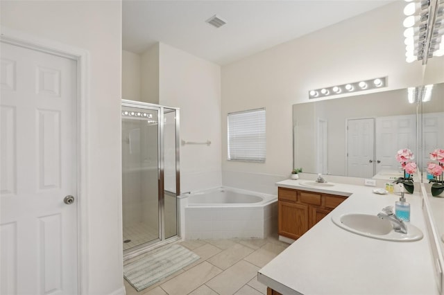 bathroom featuring tile patterned floors, separate shower and tub, and vanity