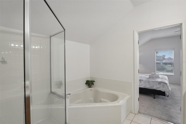 bathroom with a textured ceiling, lofted ceiling, independent shower and bath, and tile patterned flooring