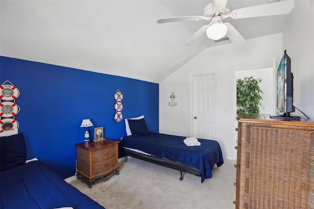 bedroom with lofted ceiling, ceiling fan, and carpet flooring