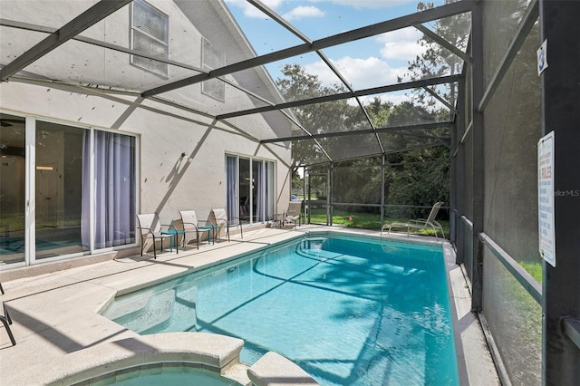 view of swimming pool featuring a patio and a lanai