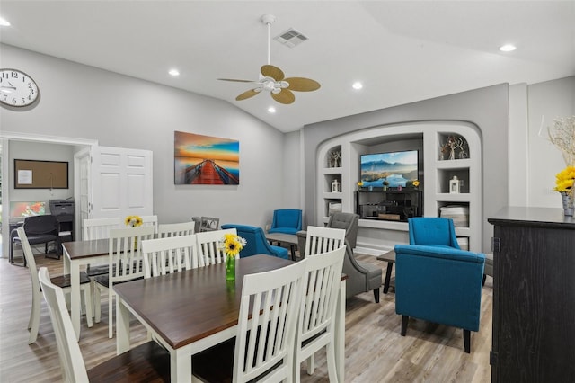 dining space featuring built in features, light hardwood / wood-style flooring, ceiling fan, and lofted ceiling