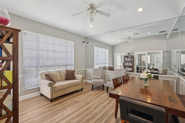 living room featuring french doors, ceiling fan, vaulted ceiling, and light hardwood / wood-style flooring