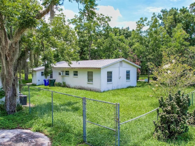 rear view of house featuring a lawn