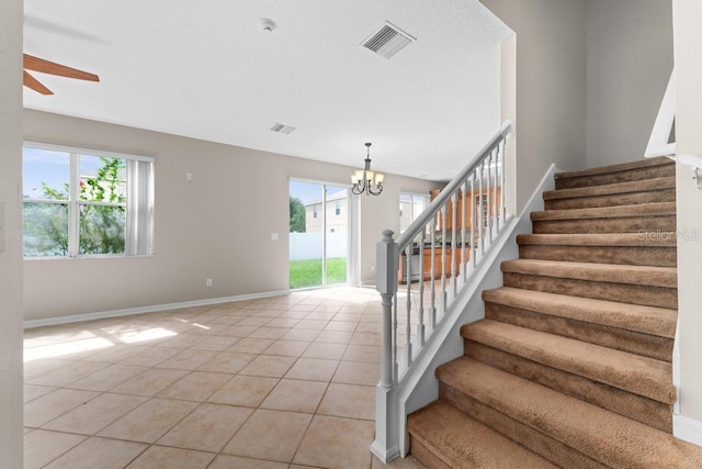 10617 Bamboo Rod Cir, Riverview, FL 33569 - staircase with plenty of natural light, ceiling fan, tile patterned floors, and baseboards