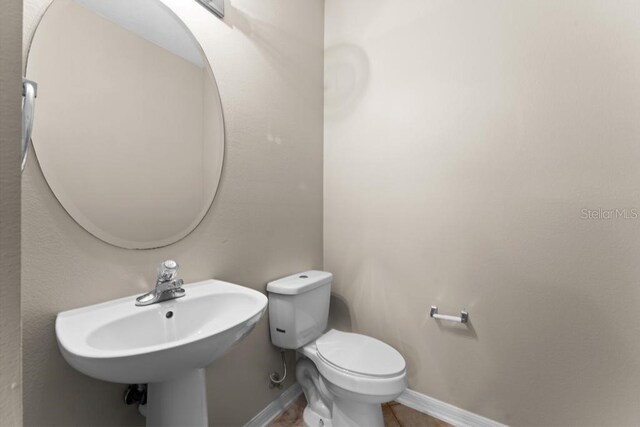10617 Bamboo Rod Cir, Riverview, FL 33569 - bathroom with toilet, baseboards, and a sink