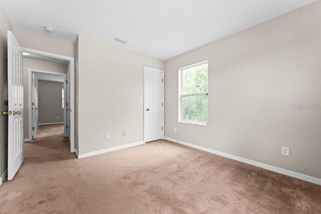 10617 Bamboo Rod Cir, Riverview, FL 33569 - unfurnished bedroom featuring light colored carpet and baseboards