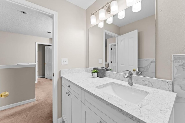10617 Bamboo Rod Cir, Riverview, FL 33569 - bathroom featuring vanity, a textured ceiling, and baseboards