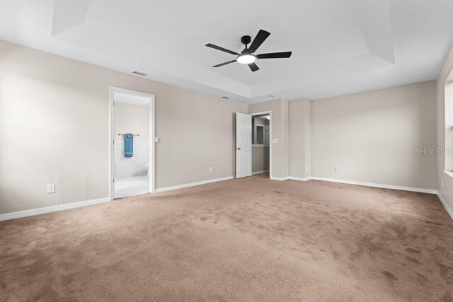 10617 Bamboo Rod Cir, Riverview, FL 33569 - unfurnished bedroom featuring a raised ceiling, carpet flooring, baseboards, and ensuite bath