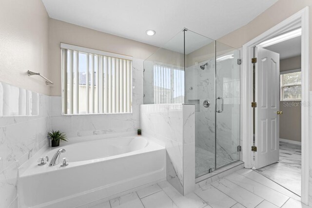 10617 Bamboo Rod Cir, Riverview, FL 33569 - bathroom with marble finish floors, a garden tub, and a marble finish shower