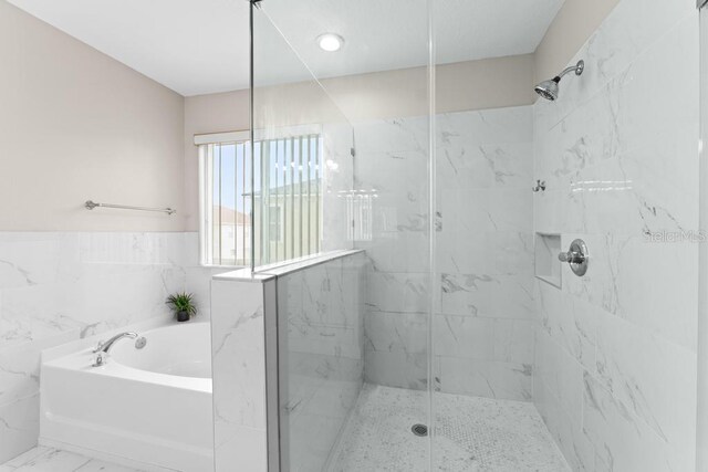 10617 Bamboo Rod Cir, Riverview, FL 33569 - bathroom featuring a marble finish shower, a bath, and marble finish floors