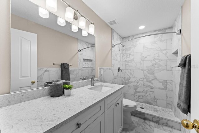 10617 Bamboo Rod Cir, Riverview, FL 33569 - bathroom with marble finish floors, a tile shower, vanity, toilet, and recessed lighting