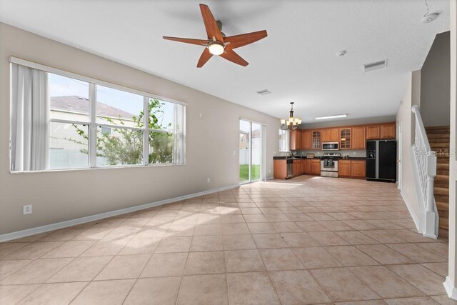 10617 Bamboo Rod Cir, Riverview, FL 33569 - unfurnished living room featuring a chandelier, baseboards, stairs, a ceiling fan, and light tile patterned floors