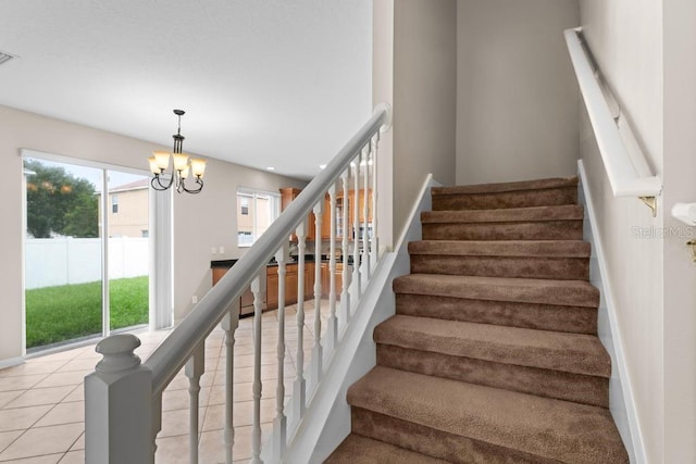 10617 Bamboo Rod Cir, Riverview, FL 33569 - stairs with healthy amount of natural light, a chandelier, baseboards, and tile patterned floors