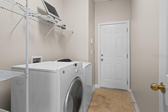 10617 Bamboo Rod Cir, Riverview, FL 33569 - laundry room featuring washing machine and dryer and baseboards