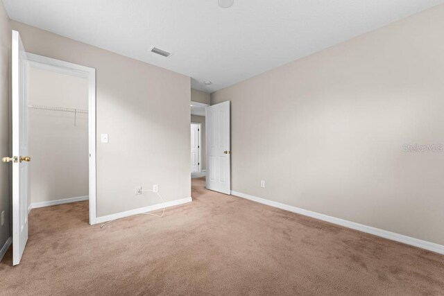 10617 Bamboo Rod Cir, Riverview, FL 33569 - unfurnished bedroom with light colored carpet, baseboards, a spacious closet, and a closet