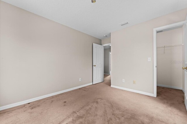 10617 Bamboo Rod Cir, Riverview, FL 33569 - unfurnished bedroom with carpet, a spacious closet, baseboards, and a closet