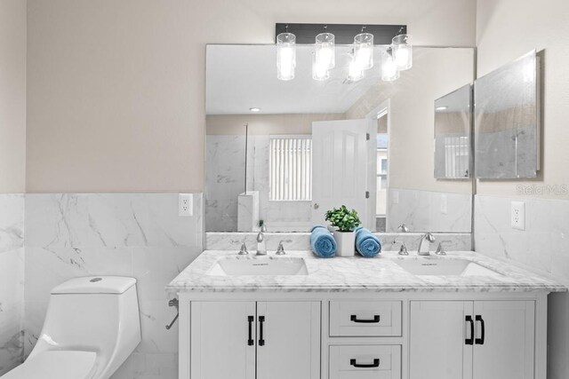 10617 Bamboo Rod Cir, Riverview, FL 33569 - full bath with tile walls, toilet, wainscoting, and double vanity