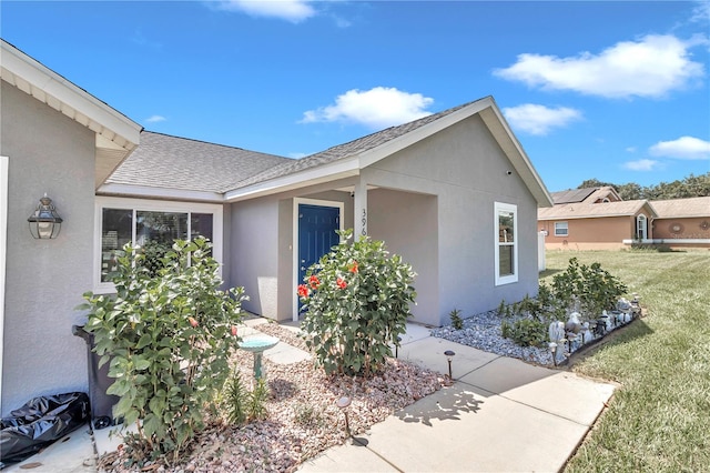 view of side of home with a yard