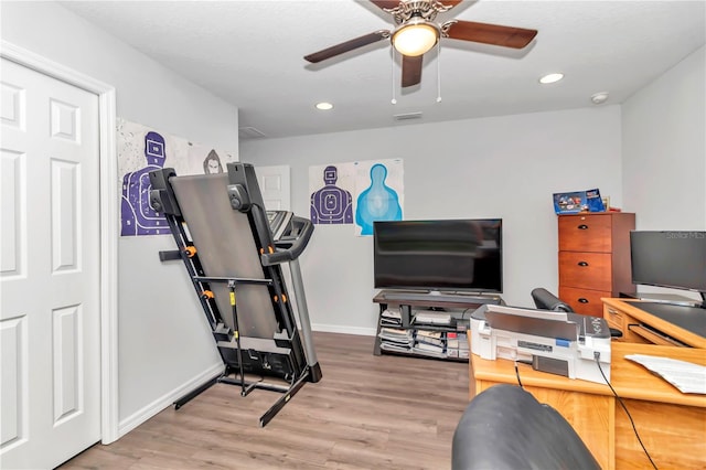 exercise room featuring hardwood / wood-style flooring and ceiling fan