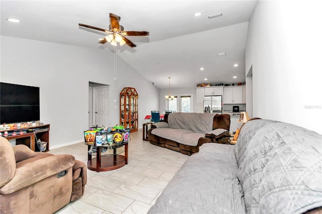 tiled living room with ceiling fan and high vaulted ceiling