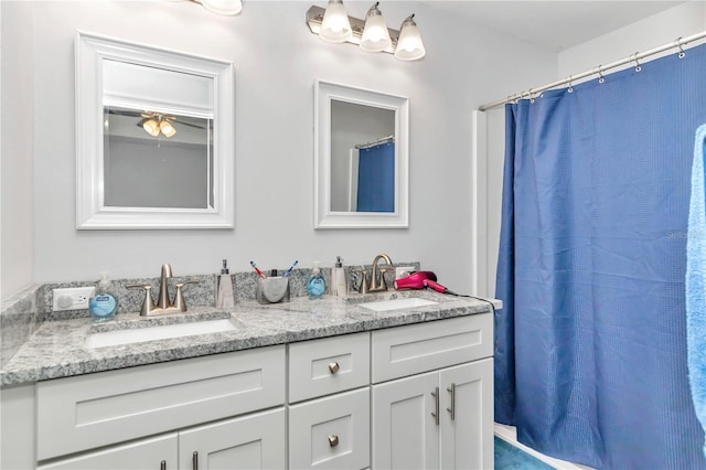 bathroom with curtained shower and vanity