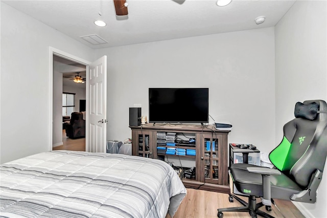 bedroom with ceiling fan and light wood-type flooring