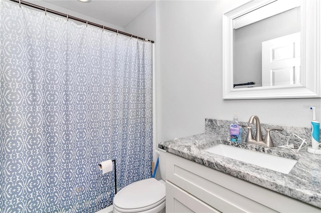 bathroom with vanity, toilet, and curtained shower