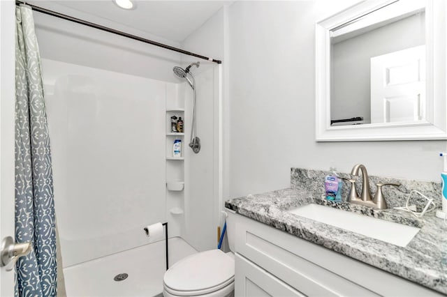 bathroom with vanity, toilet, and walk in shower