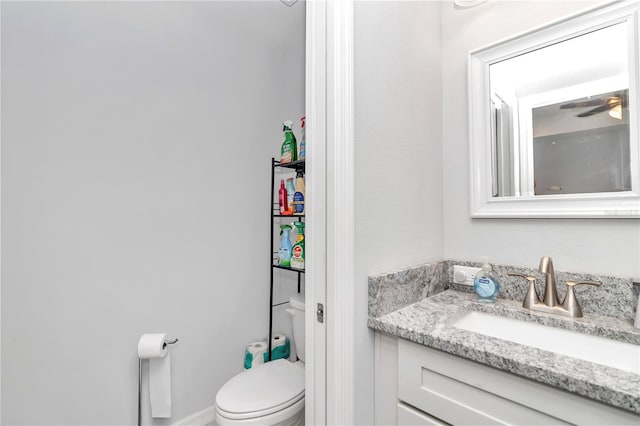 bathroom with ceiling fan, toilet, and vanity