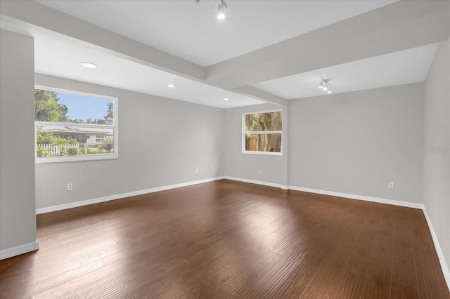 unfurnished room featuring dark wood-type flooring, recessed lighting, and baseboards