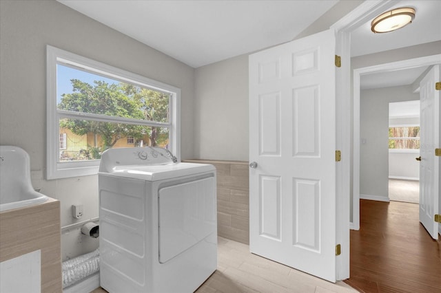 washroom with washer / dryer, laundry area, and light wood-style floors