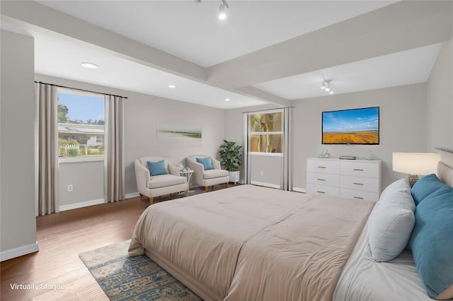 bedroom with recessed lighting, wood finished floors, and baseboards