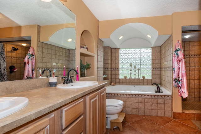 full bathroom with plus walk in shower, tile patterned flooring, toilet, vanity, and a textured ceiling