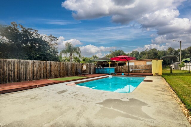 view of pool with a yard and a deck