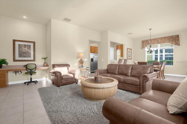 living room featuring light tile patterned flooring and an inviting chandelier