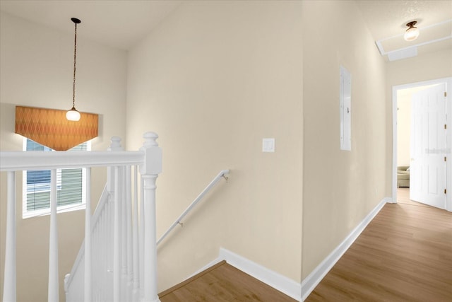 hallway featuring hardwood / wood-style flooring and lofted ceiling