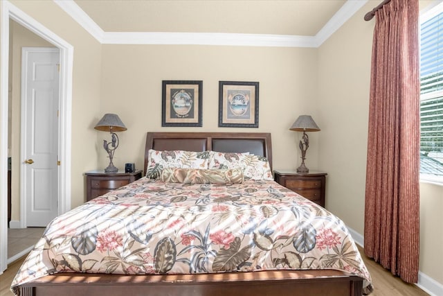 bedroom with light hardwood / wood-style flooring and ornamental molding