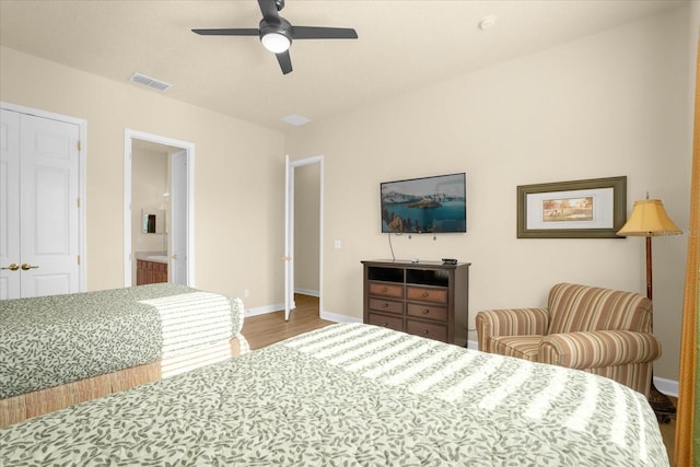 bedroom featuring ceiling fan, hardwood / wood-style floors, and ensuite bath