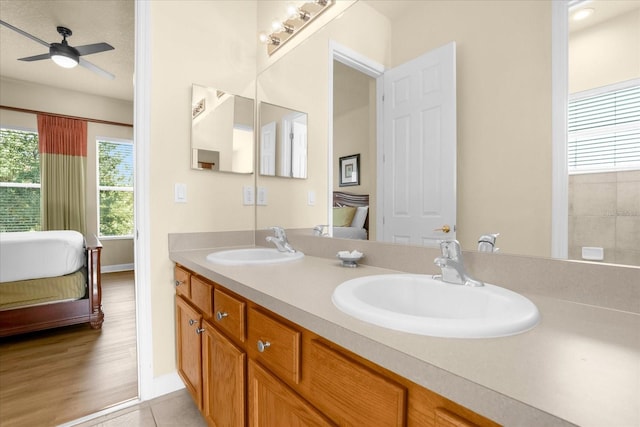 bathroom featuring ceiling fan, hardwood / wood-style flooring, a textured ceiling, and vanity