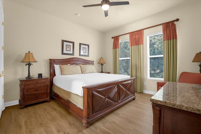 bedroom with ceiling fan and light wood-type flooring